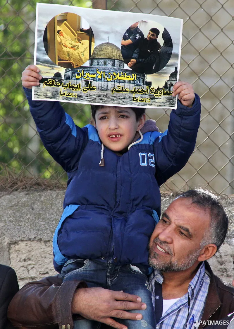 Palestinians take part during a protest to show solidarity with Palestinian children prisoner at Israeli jails outside an Israeli court in Jerusalem on January 31, 2016. Photo by Mahfouz Abu Turk