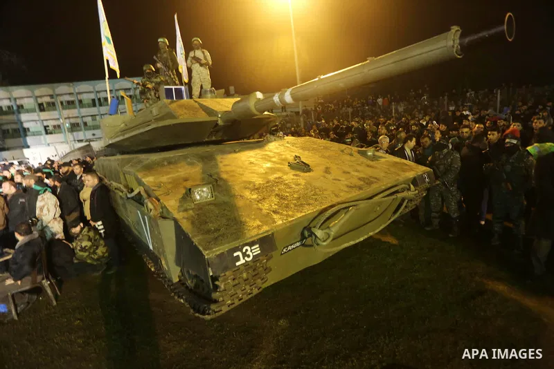 Palestinian members of the Ezzedine al-Qassam Brigades, the armed wing of the Hamas movement, gather around a mock Israeli tank on January 31, 2016 in Gaza city during a gathering to pay tribute to the brigade's militant...