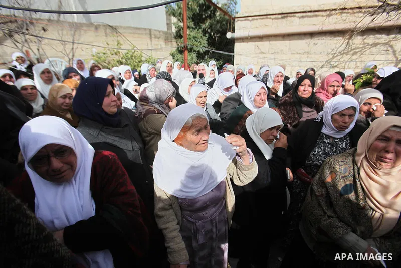 Relatives of a Palestinian gunman Amjad Abu Omar, whom the Israeli army said was shot dead by soldiers after he wounded three Israelis on Sunday, mourn during his funeral in the West Bank village of Jamain near Nablus Fe...
