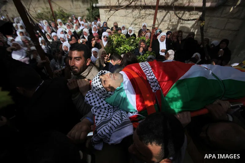 Mourners carry the body of Palestinian gunman Amjad Abu Omar, whom the Israeli army said was shot dead by soldiers after he wounded three Israelis on Sunday, during his funeral in the West Bank village of Jamain near Nab...