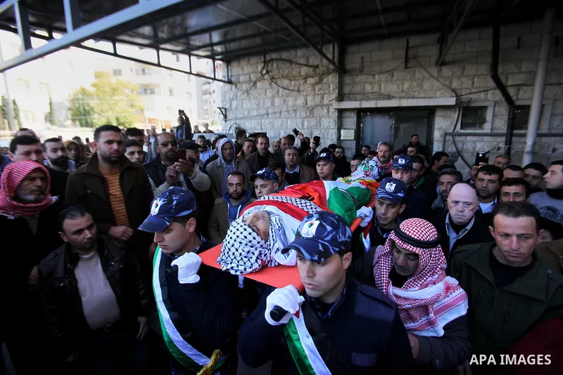 Palestinian policemen carry the body of Palestinian gunman Amjad Abu Omar, whom the Israeli army said was shot dead by soldiers after he wounded three Israelis on Sunday, during his funeral in the West Bank village of Ja...
