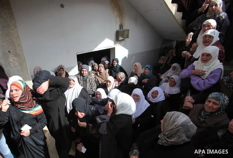 Relatives of a Palestinian gunman Amjad Abu Omar, whom the Israeli army said was shot dead by soldiers after he wounded three Israelis on Sunday, mourn during his funeral in the West Bank village of Jamain near Nablus Fe...