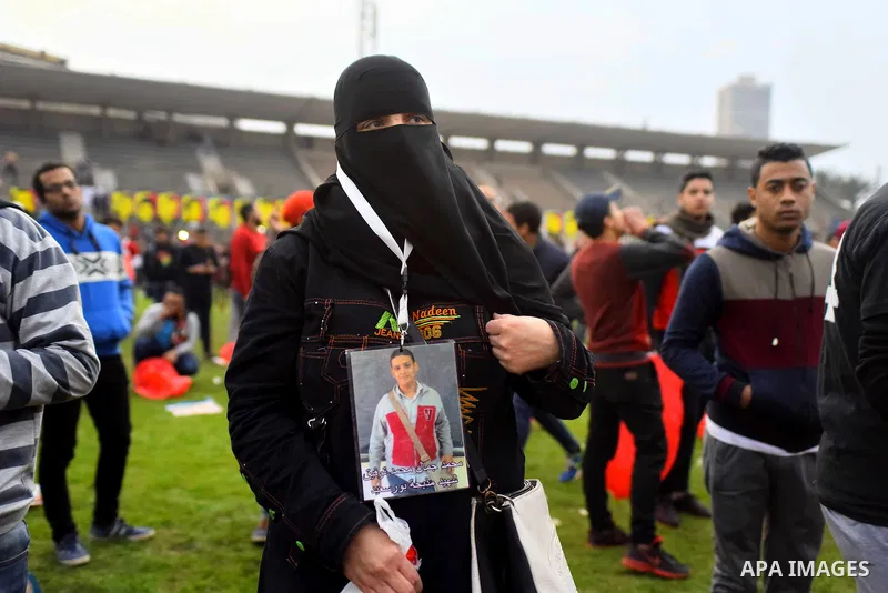 Relatives of al-Ahly fans, who were killed in what known as the "Port Said massacre", attend the fourth anniversary of killing their relatives at al-Ahly club's training stadium, on February 1, 2016. On 1 February 2012,...