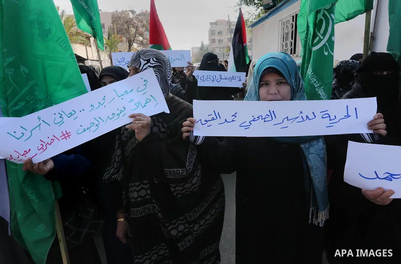 Palestinian women hold banners during a protest to show solidarity with journalist Mohammed al-Qiq who is imprisoned in an Israeli jail, Gaza city, on February 02, 2016. Photo by Mohammed Asad