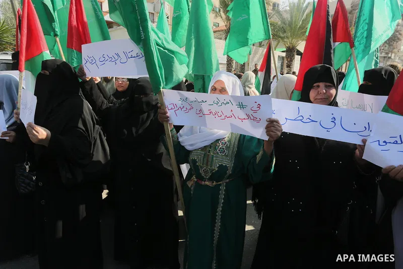 Palestinian women hold banners during a protest to show solidarity with journalist Mohammed al-Qiq who is imprisoned in an Israeli jail, Gaza city, on February 02, 2016. Photo by Mohammed Asad