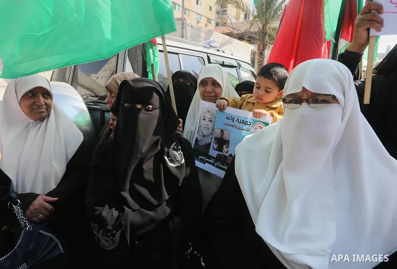 Palestinian women hold banners during a protest to show solidarity with journalist Mohammed al-Qiq who is imprisoned in an Israeli jail, Gaza city, on February 02, 2016. Photo by Mohammed Asad