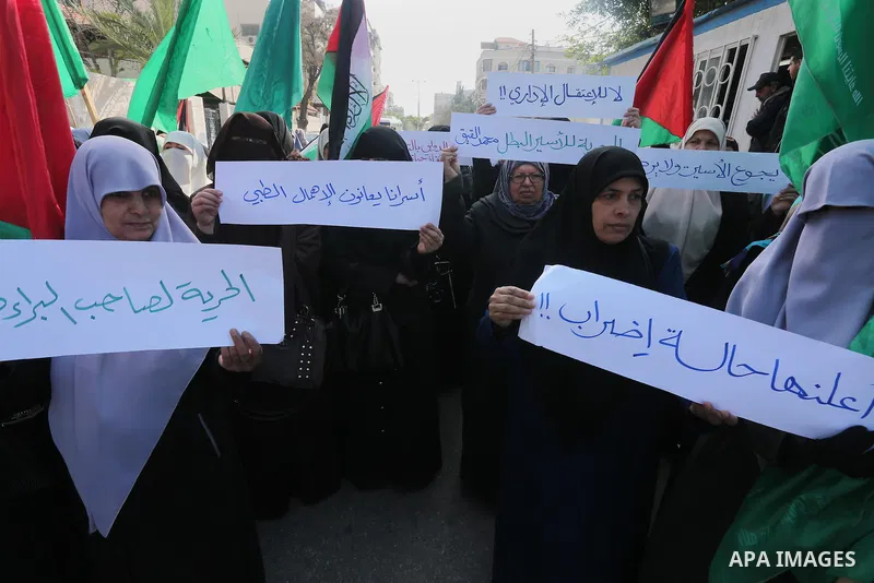 Palestinian women hold banners during a protest to show solidarity with journalist Mohammed al-Qiq who is imprisoned in an Israeli jail, Gaza city, on February 02, 2016. Photo by Mohammed Asad