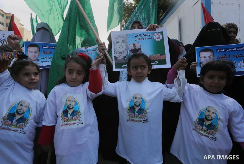 Palestinian women hold banners during a protest to show solidarity with journalist Mohammed al-Qiq who is imprisoned in an Israeli jail, Gaza city, on February 02, 2016. Photo by Mohammed Asad