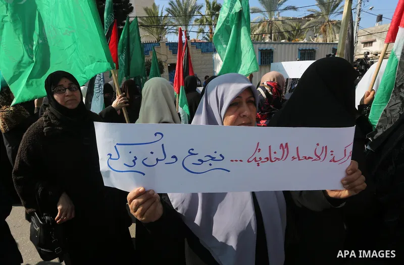 Palestinian women hold banners during a protest to show solidarity with journalist Mohammed al-Qiq who is imprisoned in an Israeli jail, Gaza city, on February 02, 2016. Photo by Mohammed Asad