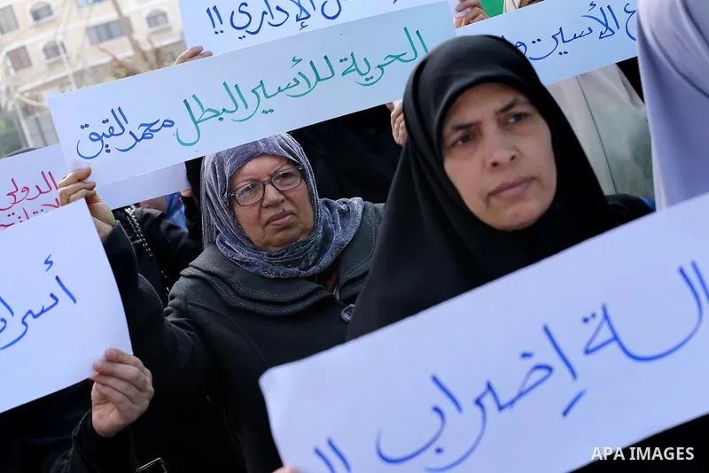 Palestinian women hold banners during a protest to show solidarity with journalist Mohammed al-Qiq who is imprisoned in an Israeli jail, Gaza city, on February 02, 2016. Photo by Mohammed Asad