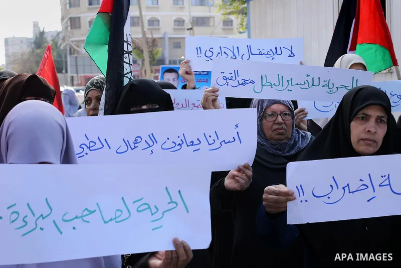 Palestinian women hold banners during a protest to show solidarity with journalist Mohammed al-Qiq who is imprisoned in an Israeli jail, Gaza city, on February 02, 2016. Photo by Mohammed Asad