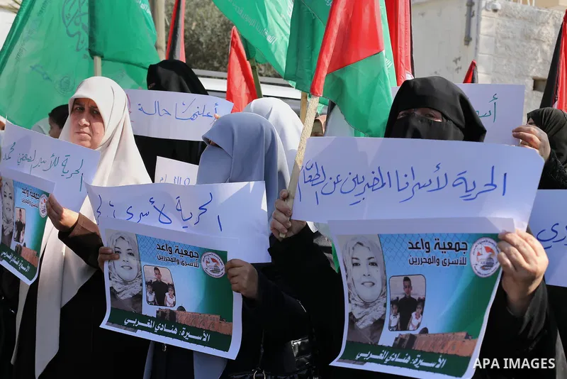 Palestinian women hold banners during a protest to show solidarity with journalist Mohammed al-Qiq who is imprisoned in an Israeli jail, Gaza city, on February 02, 2016. Photo by Mohammed Asad