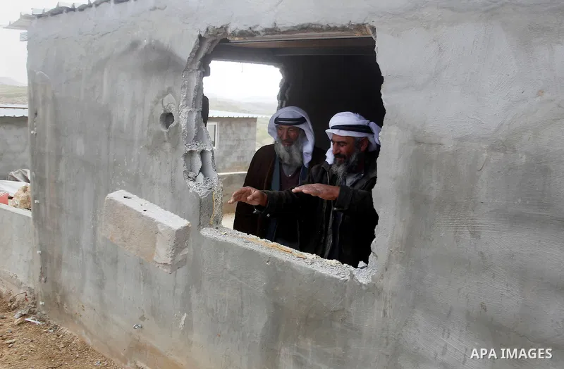 Palestinians check damage of their home after it was demolished by Israeli bulldozers in a disputed military zone in the area of Musafir Jenbah, which includes several villages, south of the West Bank town of Hebron on F...