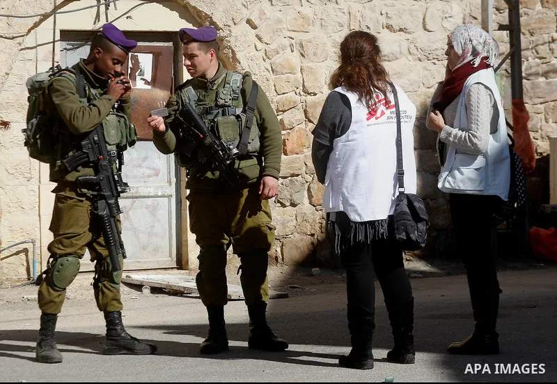 Israeli army soldiers stand gaurd in front of houses which Israeli settlers try to take over, in the West Bank city of Hebron, 03 February 2016. The building is near the religious site known to Jews as the Cave of the Pa...