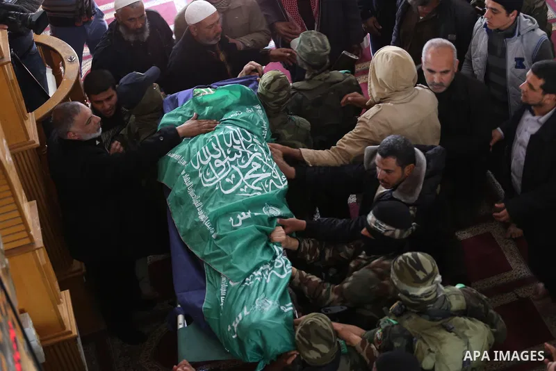 Palestinian militants carry the body of their comrade Fuad Abu Atewi, who was killed when a tunnel collapse on Tuesday, during his funeral in the village of Al-Moghraga near the Nuseirat refugee camp in the central Gaza...