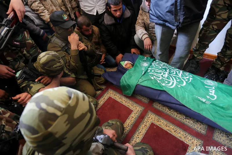 Palestinian militants mourn around the body of Fuad Abu Atewi, who was killed when a tunnel collapse on Tuesday, mourn during his funeral in the village of Al-Moghraga near central Gaza Strip, February 3, 2016. The colla...