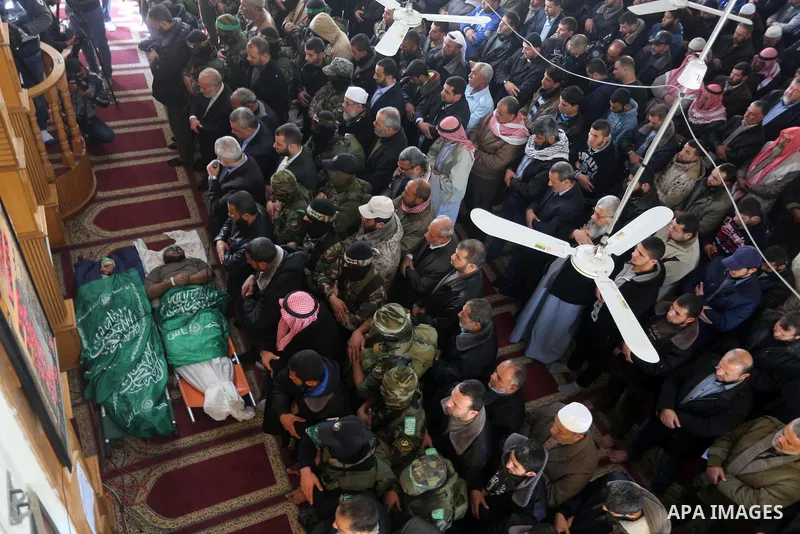 Palestinians pray in front of the bodies of Hamas militant Ahmed al-Zahar and Fuad Abu Atewi whom killed when a tunnel collapse on Tuesday, during his funeral in the village of Al-Moghraga near central Gaza Strip, Februa...