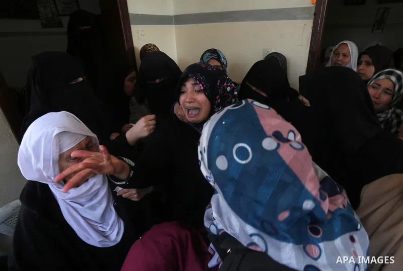 Relatives of Palestinian Hamas militant Ahmed al-Zahar, who was killed when a tunnel collapse on Tuesday, mourn during his funeral in the village of Al-Moghraga near central Gaza Strip, February 3, 2016. The collapse of...