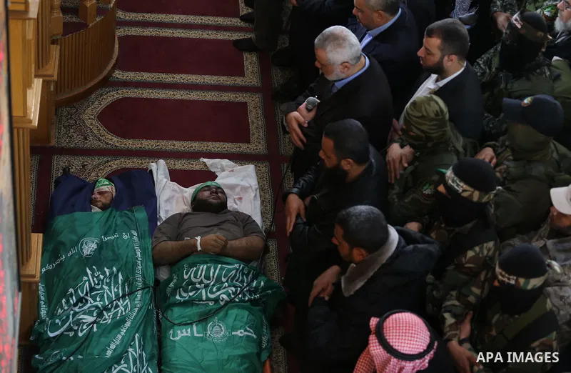 Palestinians pray in front of the bodies of Hamas militant Ahmed al-Zahar and Fuad Abu Atewi whom killed when a tunnel collapse on Tuesday, during his funeral in the village of Al-Moghraga near central Gaza Strip, Februa...