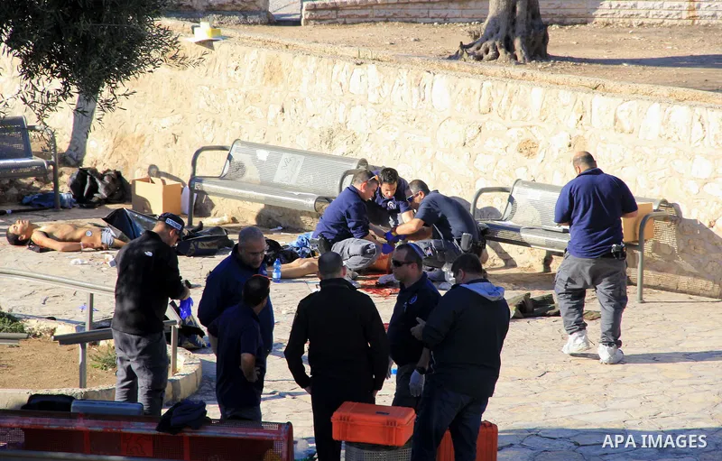 Israeli police officers inspect the bodies of two of the reported Palestinian assailants who were killed following an attack at Damascus Gate, a main entrance to Jerusalem's Old City on February 3, 2016. Three Palestinia...