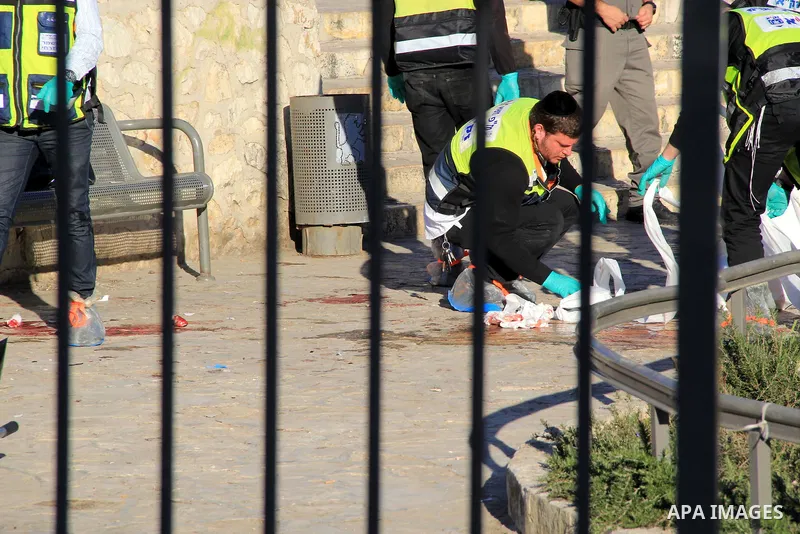 Ultra-Orthodox Jewish Zaka volunteers stand next to the blood-stained equipment of an Israeli member of security forces following an attack by reported Palestinian assailants at Damascus Gate, a main entrance to Jerusale...
