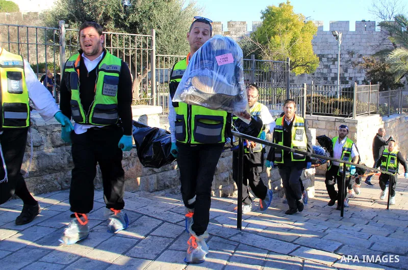 Ultra-Orthodox Jewish Zaka volunteers carry the bodies of two of the reported Palestinian assailants who were killed following an attack at Damascus Gate, a main entrance to Jerusalem's Old City on February 3, 2016. Thre...