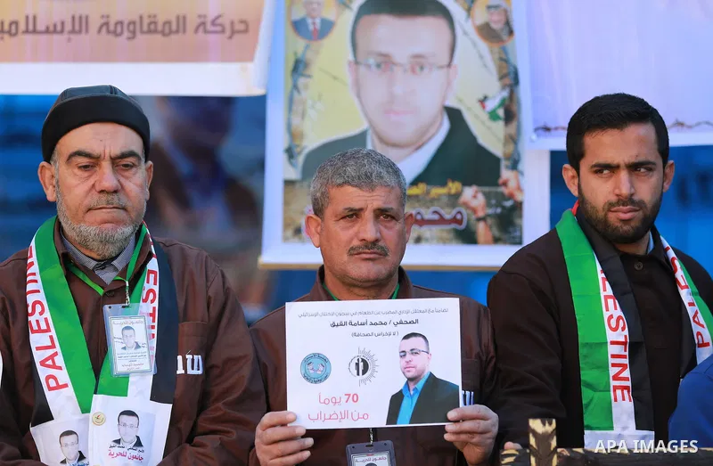 Palestinians take part in a protest to show solidarity with a Palestinian journalist Mohammed al-Qiq who is imprisoned in an Israeli jail in front of Red cross office in Gaza city on Feb. 04, 2016. Qiq is being held unde...