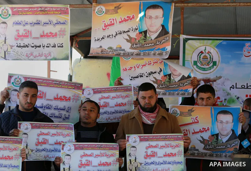 Palestinians take part in a protest to show solidarity with a Palestinian journalist Mohammed al-Qiq who is imprisoned in an Israeli jail at the Erez crossing checkpoint in the northern Gaza Strip on Feb. 04, 2016. Qiq i...
