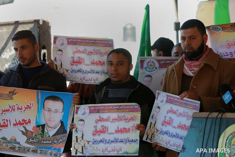 Palestinians take part in a protest to show solidarity with a Palestinian journalist Mohammed al-Qiq who is imprisoned in an Israeli jail at the Erez crossing checkpoint in the northern Gaza Strip on Feb. 04, 2016. Qiq i...