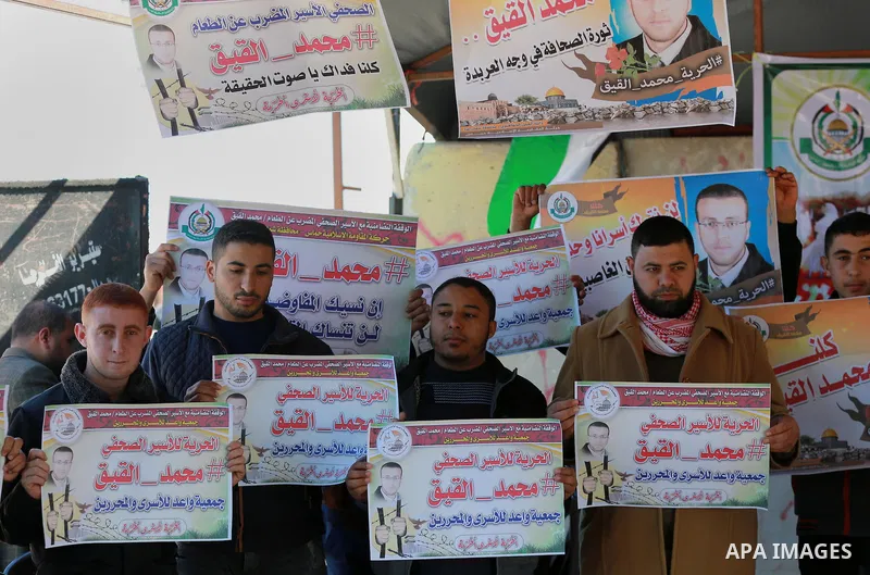 Palestinians take part in a protest to show solidarity with a Palestinian journalist Mohammed al-Qiq who is imprisoned in an Israeli jail at the Erez crossing checkpoint in the northern Gaza Strip on Feb. 04, 2016. Qiq i...