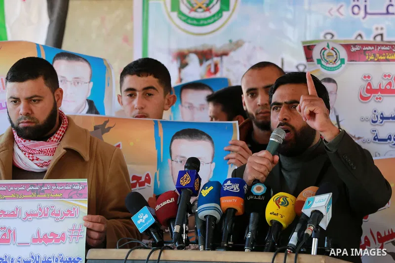 Mushir Al Masri, a Hamas MP and media spokesman speaks during a protest to show solidarity with a Palestinian journalist Mohammed al-Qiq who is imprisoned in an Israeli jail at the Erez crossing checkpoint in the norther...