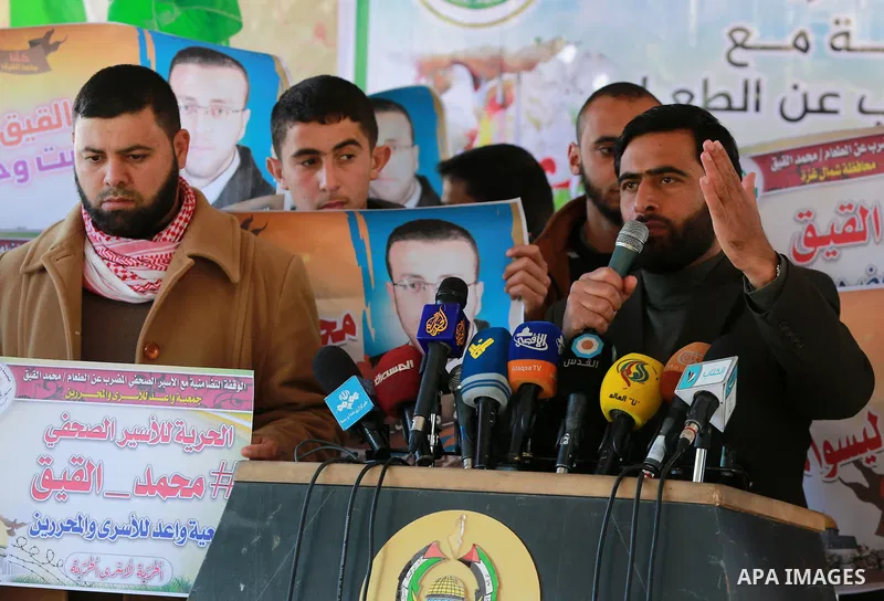 Mushir Al Masri, a Hamas MP and media spokesman speaks during a protest to show solidarity with a Palestinian journalist Mohammed al-Qiq who is imprisoned in an Israeli jail at the Erez crossing checkpoint in the norther...