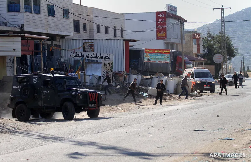 Palestinian protesters hurl stones toward Israeli security forces during clashes in Qabatiya, a town near Jenin in the north of the Israeli-occupied West Bank, on February 4, 2016. Israeli forces locked down Qabatiya tha...