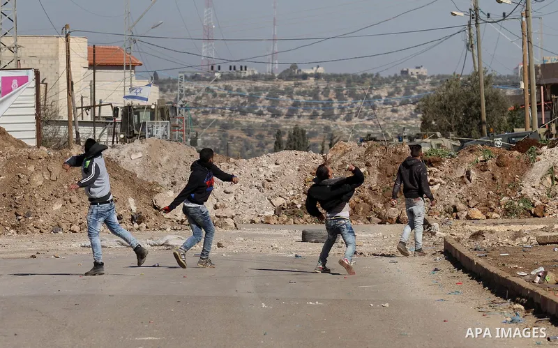 Palestinian protesters hurl stones toward Israeli security forces during clashes in Qabatiya, a town near Jenin in the north of the Israeli-occupied West Bank, on February 4, 2016. Israeli forces locked down Qabatiya tha...