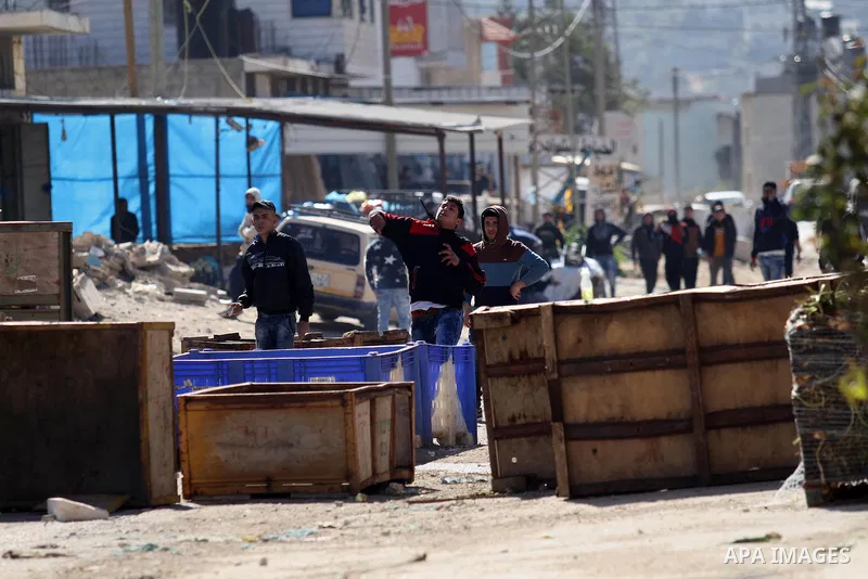 Palestinian protesters hurl stones toward Israeli security forces during clashes in Qabatiya, a town near Jenin in the north of the Israeli-occupied West Bank, on February 4, 2016. Israeli forces locked down Qabatiya tha...