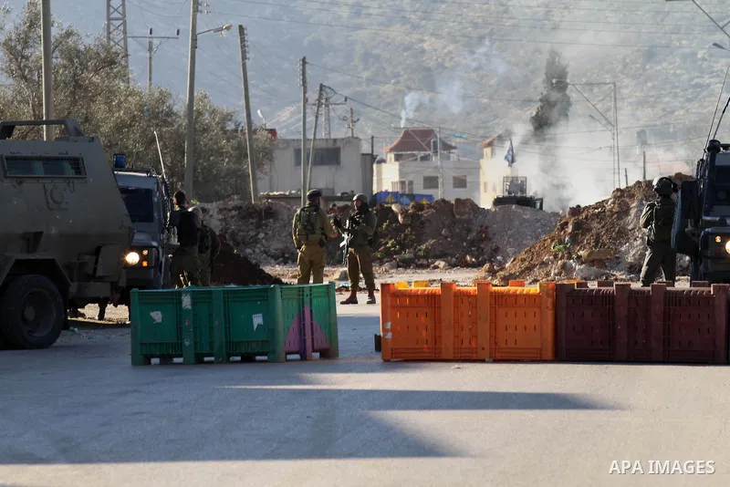 Israeli security forces take a position during clashes with Palestinian protesters in Qabatiya, a town near Jenin in the north of the Israeli-occupied West Bank, on February 4, 2016. Israeli forces locked down Qabatiya t...