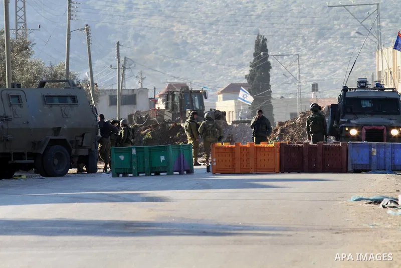 Israeli security forces take a position during clashes with Palestinian protesters in Qabatiya, a town near Jenin in the north of the Israeli-occupied West Bank, on February 4, 2016. Israeli forces locked down Qabatiya t...