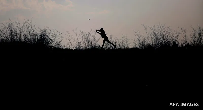 Palestinian protesters clash with Israeli security forces following a demonstration in solidarity with Palestinian prisoners in Israeli jails, outside the compound of the Israeli Ofer Military Prison, near the West Bank...