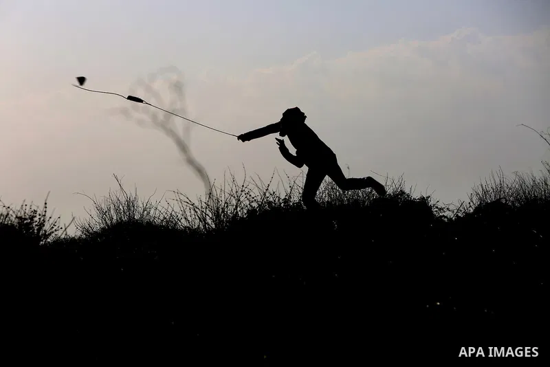 Palestinian protesters clash with Israeli security forces following a demonstration in solidarity with Palestinian prisoners in Israeli jails, outside the compound of the Israeli Ofer Military Prison, near the West Bank...