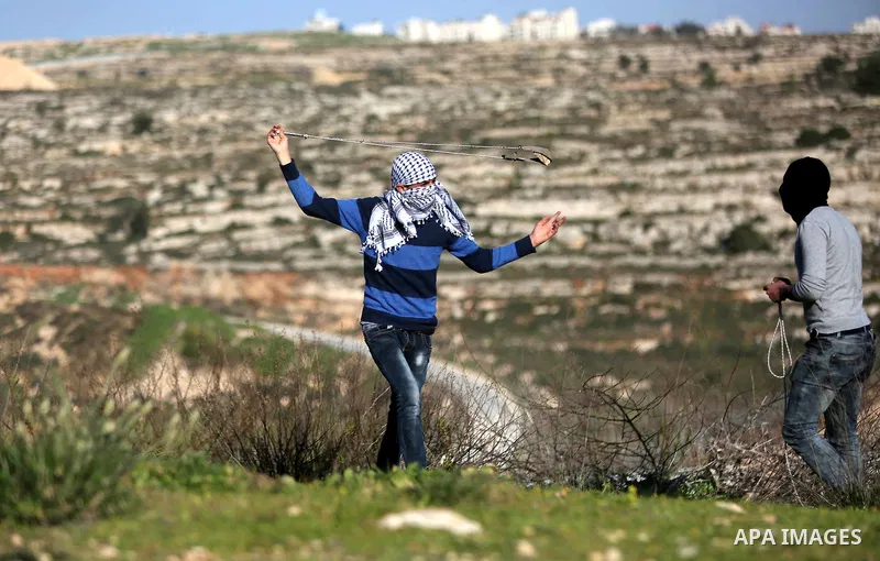 Palestinian protesters clash with Israeli security forces following a demonstration in solidarity with Palestinian prisoners in Israeli jails, outside the compound of the Israeli Ofer Military Prison, near the West Bank...