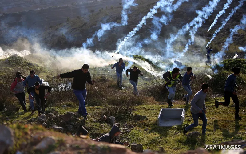 Palestinian protesters clash with Israeli security forces following a demonstration in solidarity with Palestinian prisoners in Israeli jails, outside the compound of the Israeli Ofer Military Prison, near the West Bank...