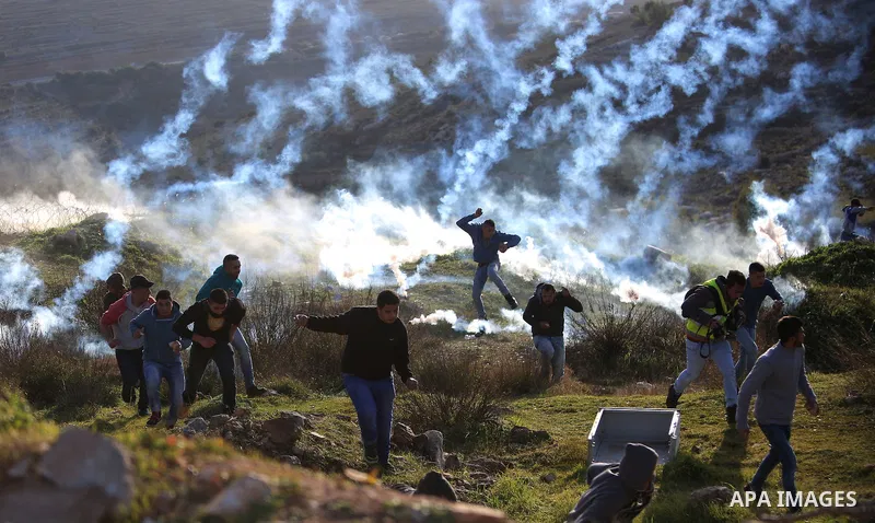 Palestinian protesters clash with Israeli security forces following a demonstration in solidarity with Palestinian prisoners in Israeli jails, outside the compound of the Israeli Ofer Military Prison, near the West Bank...