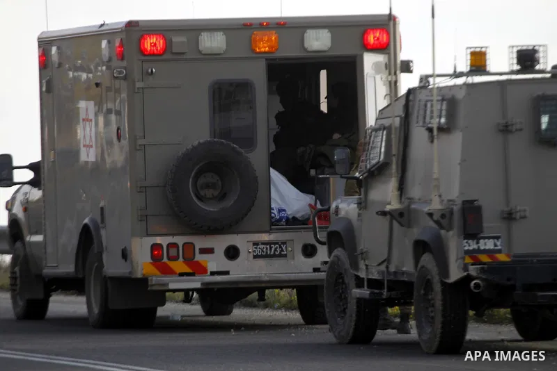 The body of a Palestinian Haitham al-Bau, who was shot dead by Israeli soldiers after throwing a petrol bomb at a military jeep, seen in Israeli military ambulance in the village of Halhul north of the Israeli occupied W...