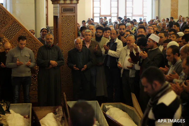 Egyptians pray in front of the body of Ahmed Seif al-Islam, son of Hassan al-Banna, founder of Egyptian Muslim Brotherhood during his funeral in Cairo, Egypt, on February. 05, 2016. Photo by Amr Sayed