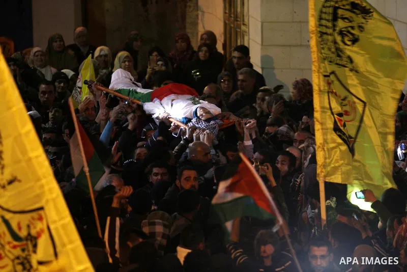 Mourners carry the body of one of the three Palestinians who were killed by Israeli security forces as they carried out a deadly attack in Jerusalem, during their funeral in the village of Qabatiya, near the West Bank ci...