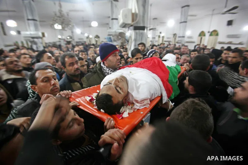 Mourners carry the body of one of the three Palestinians who were killed by Israeli security forces as they carried out a deadly attack in Jerusalem, during their funeral in the village of Qabatiya, near the West Bank ci...