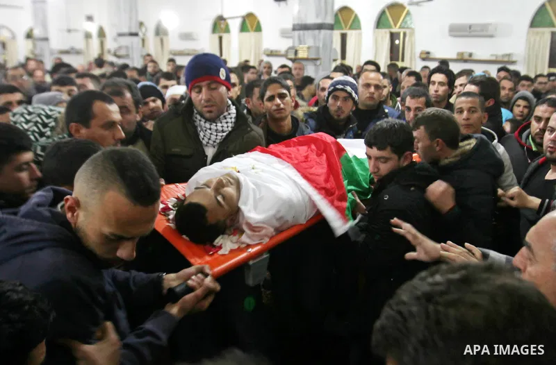 Mourners carry the body of one of the three Palestinians who were killed by Israeli security forces as they carried out a deadly attack in Jerusalem, during their funeral in the village of Qabatiya, near the West Bank ci...
