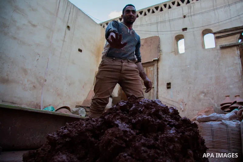 An Egyptian man works at a pottery workshop in Cairo, on February 6, 2016. Pottery is an ancient and traditional craft in Gaza. Local workshops usually produce products such as bowls, pitchers, flower pots, and vases. Ph...