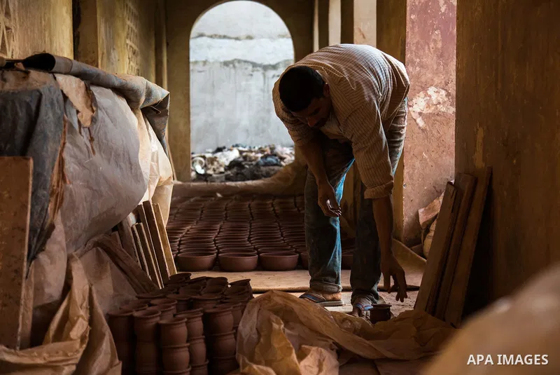 An Egyptian man works at a pottery workshop in Cairo, on February 6, 2016. Pottery is an ancient and traditional craft in Gaza. Local workshops usually produce products such as bowls, pitchers, flower pots, and vases. Ph...