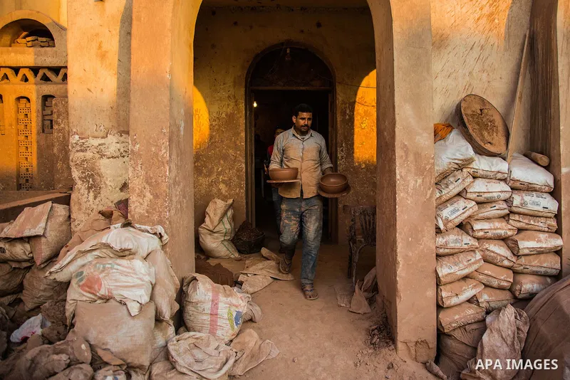 An Egyptian man works at a pottery workshop in Cairo, on February 6, 2016. Pottery is an ancient and traditional craft in Gaza. Local workshops usually produce products such as bowls, pitchers, flower pots, and vases. Ph...